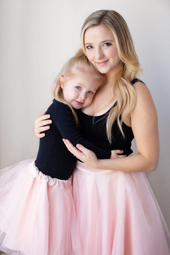 A Mother's Day Gift Portrait special in Portland, OR. This is an image of a mother and her young daughter posing in a studio. 