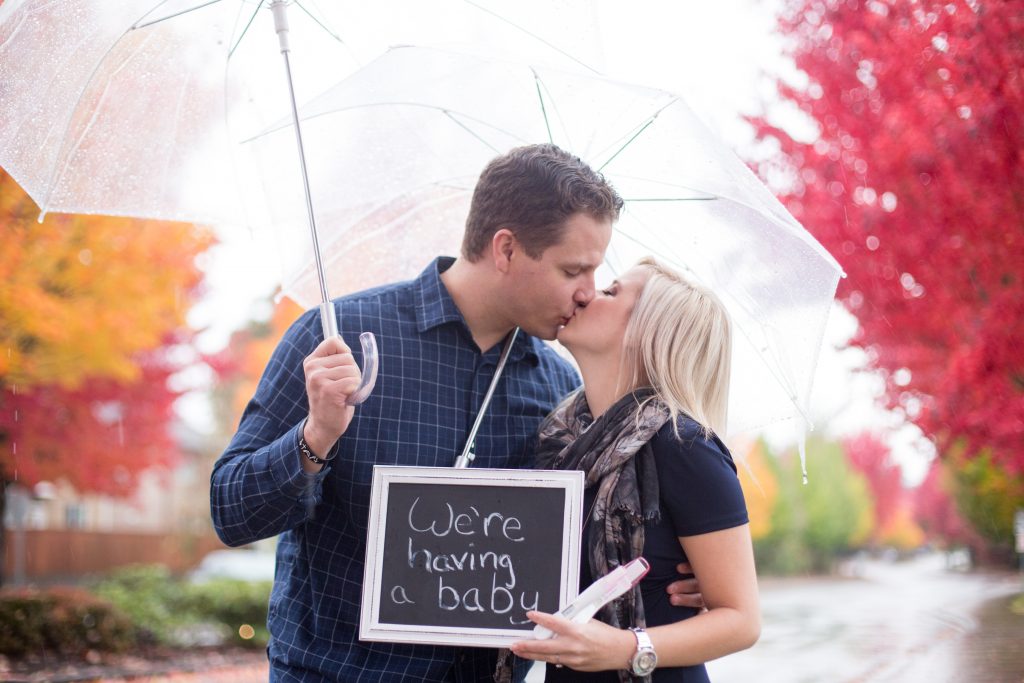 Pregnancy Announcement Idea: A Fall rainy day photo shoot. A pregnant woman is surprising her husband and letting him know his he going to be a Dad. They used chalkboards while holding umbrellas. For more info about maternity portraits, visit byRayleigh.com Photography by Rayleigh