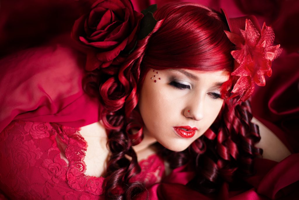 A valentine's day gift idea. Portland boudoir Photographer, Photography by Rayleigh. This woman is wearing all red and has red hair, which was a creative theme for this photo shoot.