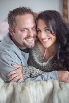 A studio couples engagement photo shoot in Portland, OR. This is a boudoir type pose lying on the bed.