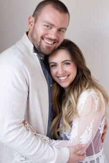 A studio couples photo shoot in Portland, OR. This a standing pose with a white background.