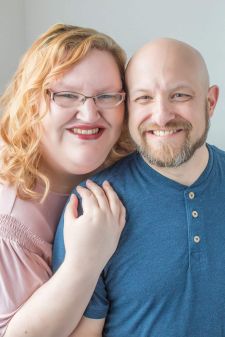 A studio couples photo shoot in Portland, OR. This is a sitting pose with a white background.