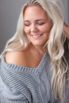 A plus size boudoir photo shoot in a studio in Portland, OR. This is a sitting pose and a close up headshot.