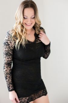 A beauty photo shoot in a studio in Portland, OR. This is a standing pose in front of a white backdrop.