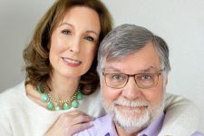 A studio couples photo shoot in Portland, OR. This is a sitting pose with a white background.