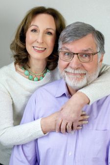 A studio couples photo shoot in Portland, OR. This is a sitting pose with a white background.