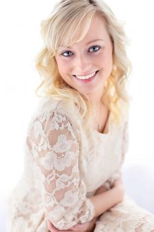 A beauty photo shoot in a studio in Portland, OR. This is a sitting pose against a window.