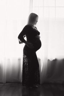 A black and white backlit boudoir maternity photo taken in a photography studio near Beaverton, OR.