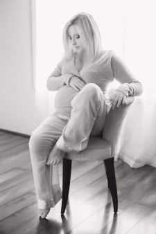 A black and white backlit boudoir maternity photo taken in a photography studio near Beaverton, OR.