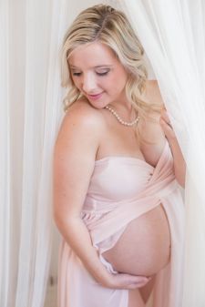 a studio boudoir maternity photo taken in Portland, OR. This is a standing pose.