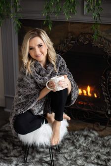 A beauty photo shoot in a studio in Portland, OR. This is a sitting pose on a stool near a fireplace.