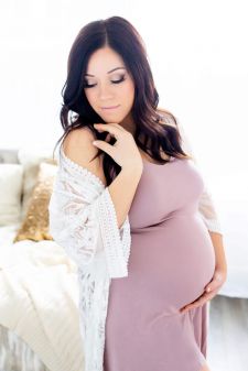 a studio boudoir maternity photo taken in Portland, OR. This is a standing pose in front of the window.