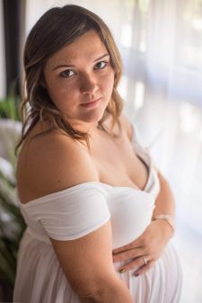 a studio boudoir maternity photo taken in Salem, OR. This is a standing pose near a window.