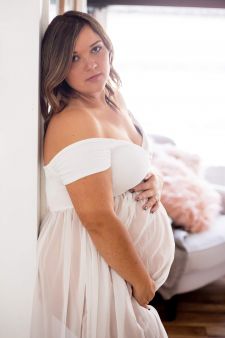 a studio boudoir maternity photo taken in Salem, OR. This is a standing wall pose.