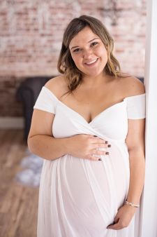 a studio boudoir maternity photo taken in Salem, OR. This is a standing wall pose.