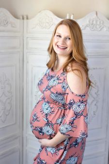 a studio maternity photo taken in Portland, OR. This is a standing pose with a smile.