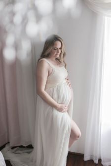 a studio maternity photo taken in Portland, OR. This is a standing pose.