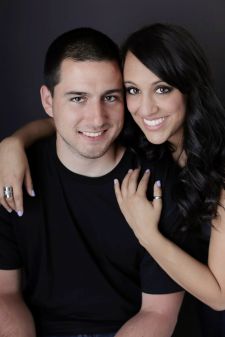 A studio couples photo shoot in Portland, OR. This is a standing pose with a black background.