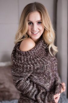 A boudoir photo shoot in a studio in Portland, OR. This is a kneeling on the bed pose.