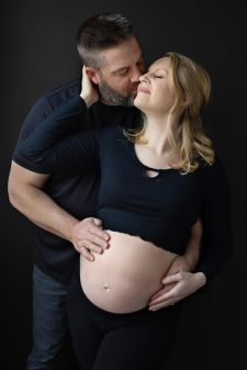 a studio couples maternity photo taken in Portland, OR. This is a standing pose.