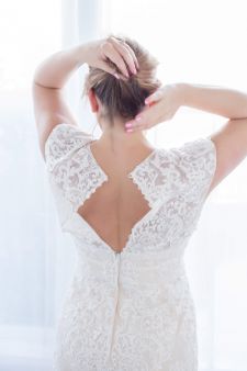 A bridal boudoir photo shoot in a studio in Portland, OR. This is a backlit window standing pose.