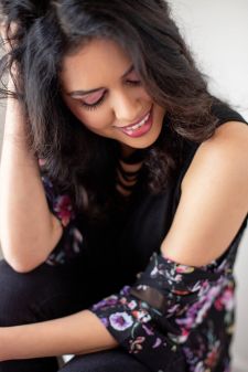 A beauty photo shoot in a studio in Portland, OR with an Indian woman. This is a close up sitting pose.
