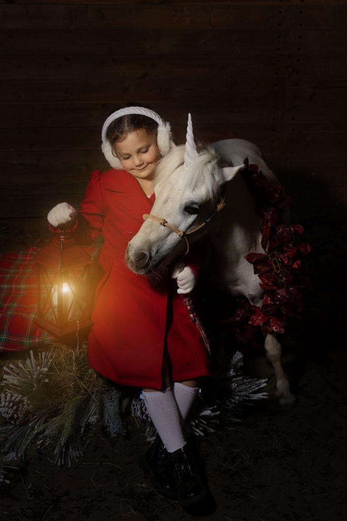 Unicorn Christmas mini sessions near Portland, OR. Stylized fine art portraits that are dark and moody with glowing light effects.